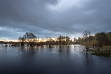 Fototapeta premium Cloudy sky with a lake in the foreground