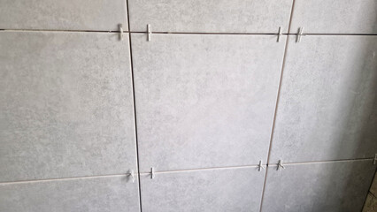 Tiles and tile spacers being installed during renovation