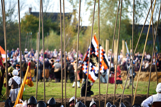 Medieval warfare with wooden peaks on battlefield fighting for the Dutch flag during the 80 Years War against Spain of the Dutch Republic
