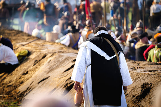 Father or monk wanders depressed across the battlefield to offer a final blessing and hope to the fallen and wounded. Cosplay battlefield .Dutch battle during the 80 years war of the Dutch Republic