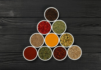 Triangle of assorted spices in bowls