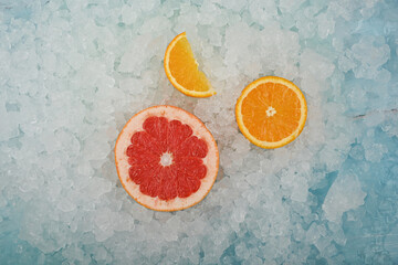 Fresh pink grapefruit and orange on ice