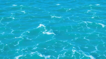 Obraz premium Tranquil blue turquoise ocean water with foamy waves, ocean, serene
