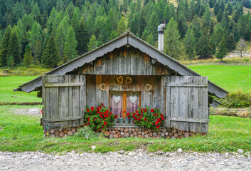 Typical architecture of wooden Cottages in the Dolomites. Old wooden house in mountains.