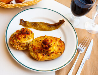 Appetizing stuffed potatoes with boiled egg closeup