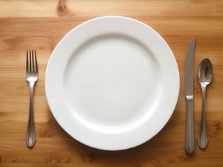 A clean dining table with a single plate and cutlery, framed with empty space around the setting to create focus 