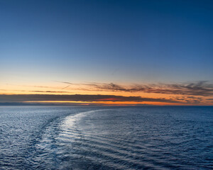 Fototapeta premium Seascape at dawn with blue sea and sky with sunrise or sunset colours
