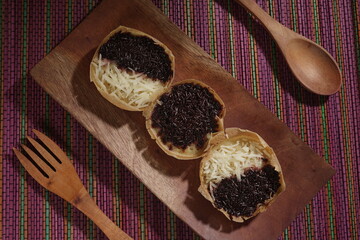 Martabak mini or terang bulan mini is Indonesian popular street food, made from flour, egg, yeast, topped with cheese or chocolate. Mini sweet martabak placed on a rainbow-colored mat