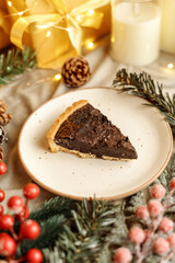 Delicious chocolate tart with Christmas decorations, surrounded by festive ornaments and holiday lights. Perfect dessert for Christmas, holiday gatherings, and winter celebrations.