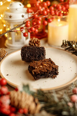 Festive Christmas brownie surrounded by holiday decorations, creating a cozy holiday vibe. Perfect for holiday season themes, Christmas treats, festive dessert spreads, and holiday celebration visuals