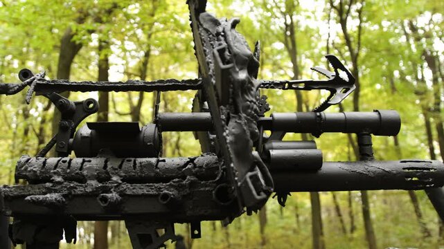 Weaponized structure, sharp attachments, reinforced metal. Detailed view showing rugged, weaponized metal structure with sharp attachments in forest setting, evoking post-apocalyptic theme.