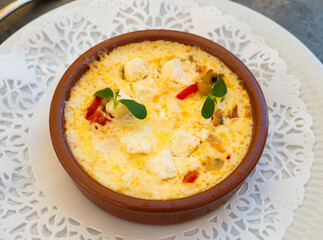 Delicate delicious vegetable vegetarian homemade pie with cheese served on clay pot on table. Flan de legumes et feta
