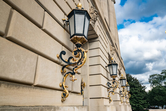 Vintage style wall street lights with gilded details on buildings in Washington, DC.
