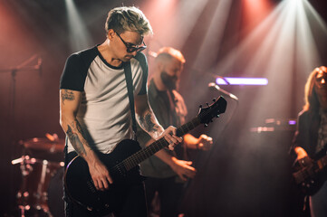 Guitarist performing live on stage with band
