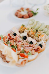 Snacks, aperitif, cold plate with meats and cheeses, party, appetizer in the restaurant
