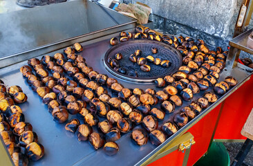 roasted chestnuts, street food, cooking on a city street