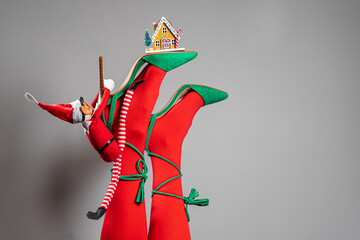 Creative Christmas background. New Year greeting card. Minimal style. Sexy female legs wearing red...