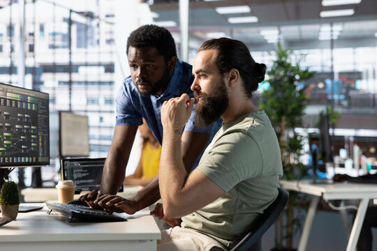 Developer requesting help from colleague while working with machine learning tech advancing AI critical to autonomous systems. IT expert and helpful coworker transforming data into predictive models