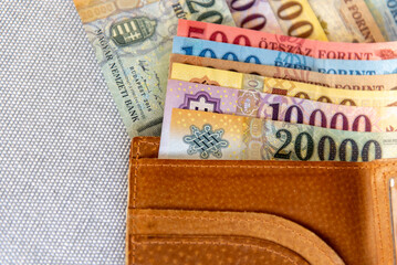 Hungarian forint banknotes in a brown leather wallet.