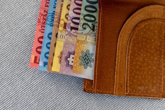 Hungarian forint banknotes in a brown leather wallet.