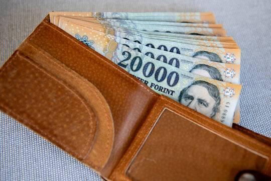 Hungarian forint banknotes in a brown leather wallet.