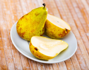 Fruits of juicy pear served at table in restaurant..