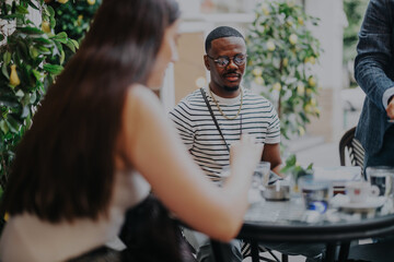 A diverse group of professionals engage in a strategy discussion and creative brainstorming in a...