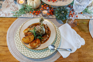 Roasted duck soup stew with garlic bread on fine China bowl and plate and silver spoon