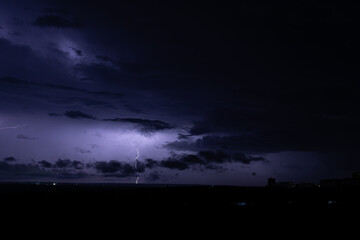 lightning in the night sky over the city