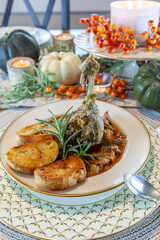 Roasted duck soup stew with garlic bread on fine China bowl and plate and silver spoon