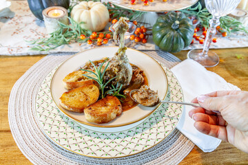 Roasted duck soup stew with garlic bread on fine China bowl and plate and silver spoon