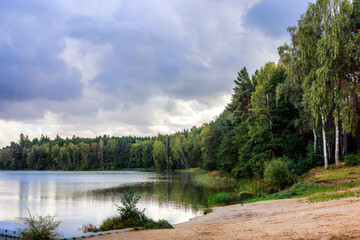 Autumn mixed forest with a beautiful lake.