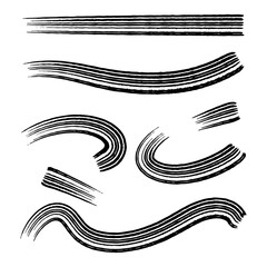 Artistic brush strokes created with black ink on a white background showcasing fluid motion and varied patterns for creative design applications