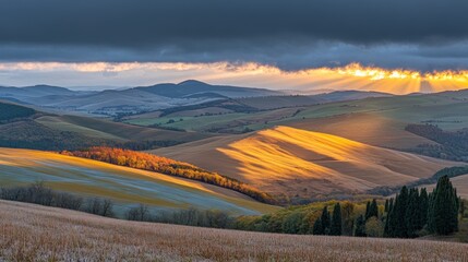 Serene landscape at sunset with rolling hills and dramatic clouds.