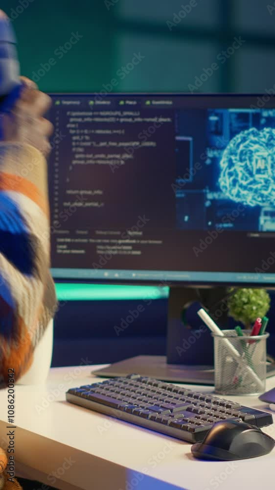 Poster vertical video african american worker at desk using personal computer for programming and data anal
