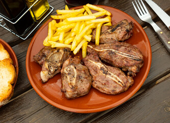 Delicious baked pork cheek with potatoes served on plate..