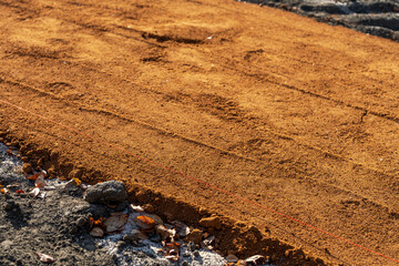 Construction photos of new baseball, softball, sports field red clay pitchers mound and infield...