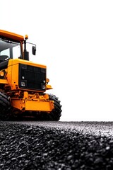A bright yellow vehicle on a gravel surface, highlighting construction and machinery against a plain white backdrop.