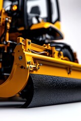 A close-up view of a yellow construction machinery component, showcasing its detailed mechanics and robust design, highlighting its practical application in roadwork.