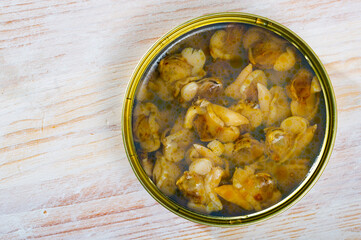 Open tin can with white clams closeup