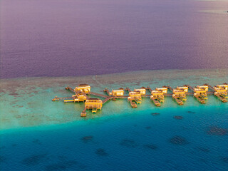 Aerial views of Velavaru Island at sunset in Maldives