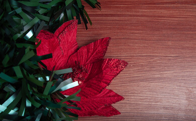 Christmas decoration detail. Red and gold Christmas decorations such as ribbon, fir branches, pine cones and Christmas tree. Background.