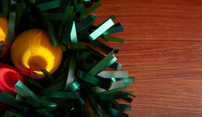 Christmas decoration detail. Red and gold Christmas decorations such as ribbon, fir branches, pine cones and Christmas tree. Background.