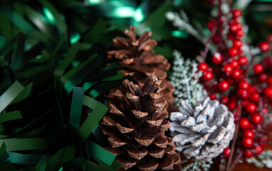 Christmas decoration detail. Red and gold, decorations such as ribbon, fir branches and pine cones.