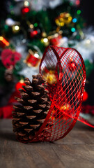 Christmas decoration detail. Red and gold, decorations such as ribbon, fir branches and pine cones.