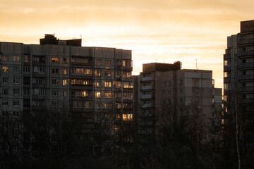 Panel apartment buildings in a residential area of Saint Petersburg, Russia, at sunrise. Sunlight reflects on facades.