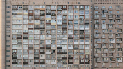Brick multi-story apartment building with variously decorated balconies and loggias, an example of Soviet architecture in Saint Petersburg, Russia.