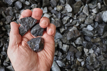 Hand holding galena ore mined for lead and silver. Lead is used in radiation protection, energy storage, batteries, sheathing protecting undersea cables