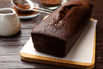 Tasty chocolate sponge cake on wooden table, closeup