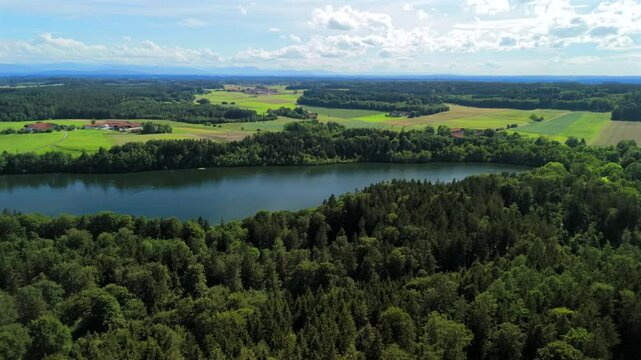 Steinsee bei Munchen Luftaufnahme. Steinsee, See in Bayern Luftbildansicht. Lake Stein aerial view near Munich, Bavaria, Germany. One of warmest lakes in Germany. Steinsee is located in forest area. 